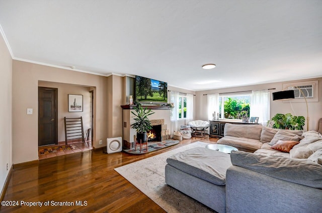 living room featuring ornamental molding, an AC wall unit, and dark wood-type flooring