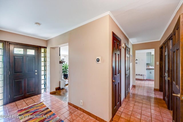 tiled foyer with ornamental molding