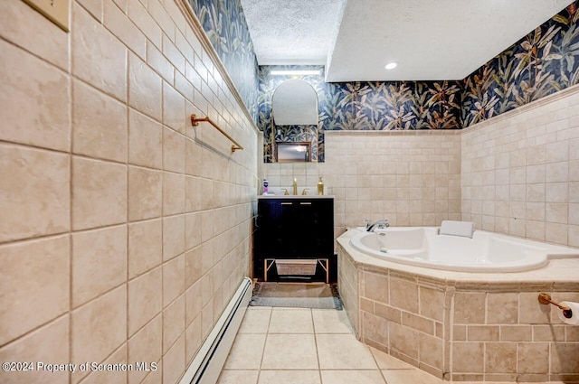 bathroom with baseboard heating, tile patterned flooring, tiled bath, a textured ceiling, and tile walls