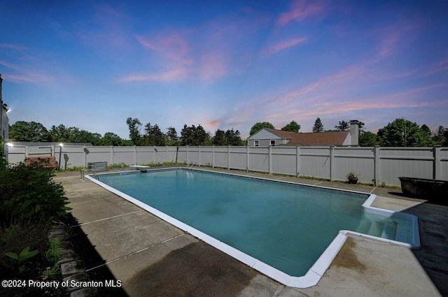 pool at dusk with a diving board