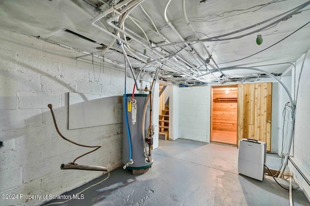 basement featuring gas water heater and baseboard heating