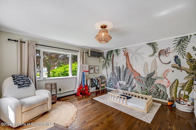 sitting room featuring baseboard heating, a wall mounted AC, and dark hardwood / wood-style floors