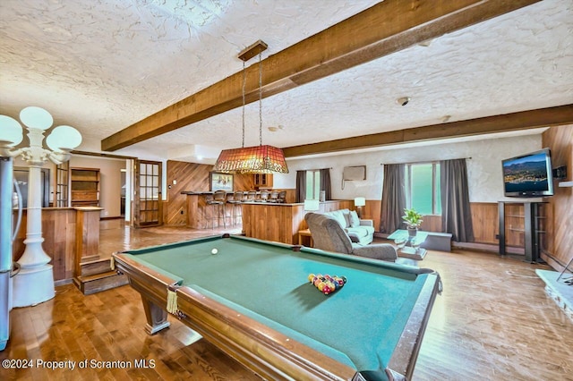 rec room with beam ceiling, billiards, wood walls, a textured ceiling, and hardwood / wood-style flooring