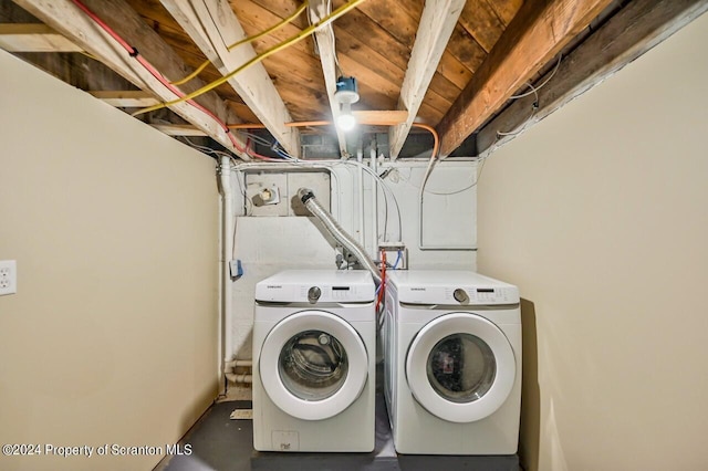 clothes washing area featuring separate washer and dryer