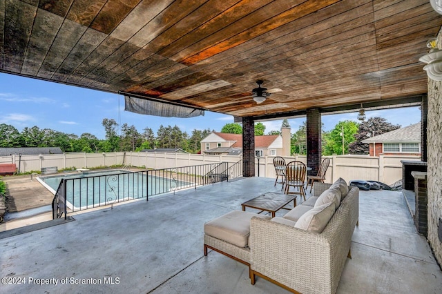 view of swimming pool with ceiling fan, a patio, and an outdoor hangout area