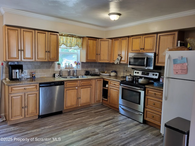 134 Taroli St, Old Forge, PA 18518 - kitchen with appliances with stainless steel finishes, a sink, crown molding, brown cabinets, and dark wood-style flooring