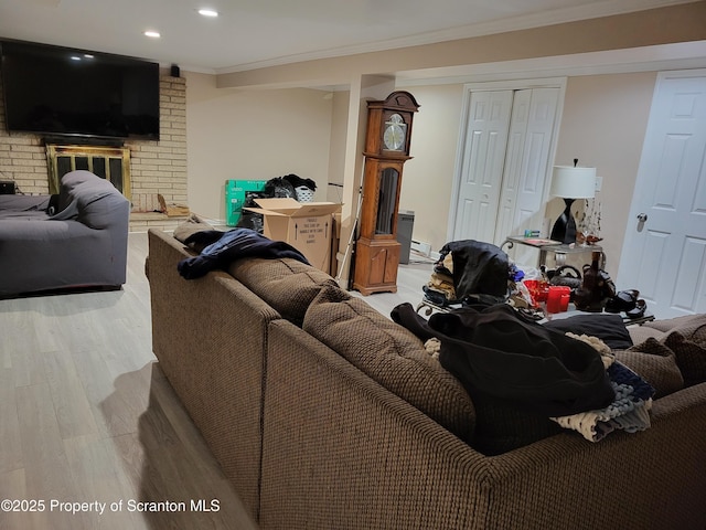 134 Taroli St, Old Forge, PA 18518 - living room with wood finished floors, ornamental molding, a fireplace, and recessed lighting