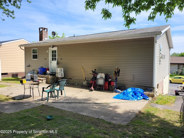 134 Taroli St, Old Forge, PA 18518 - rear view of house featuring a patio area and a chimney