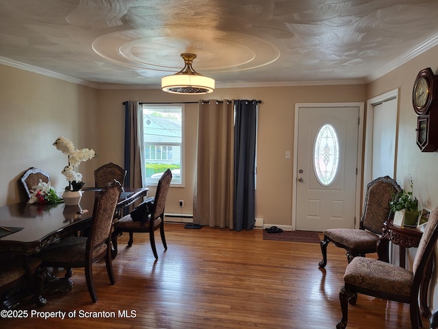 134 Taroli St, Old Forge, PA 18518 - dining room featuring light wood-type flooring, crown molding, a baseboard radiator, and baseboards