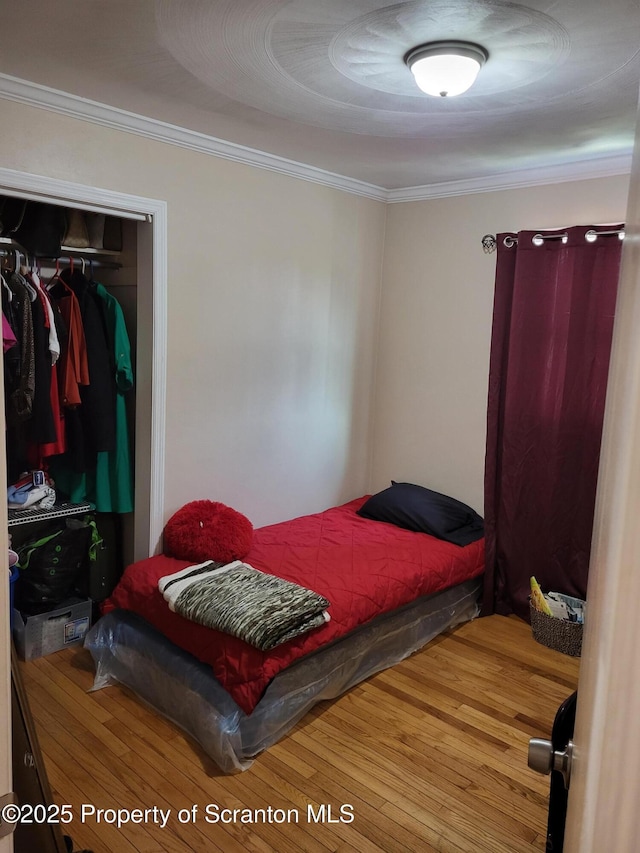 134 Taroli St, Old Forge, PA 18518 - bedroom with wood finished floors, crown molding, and a closet