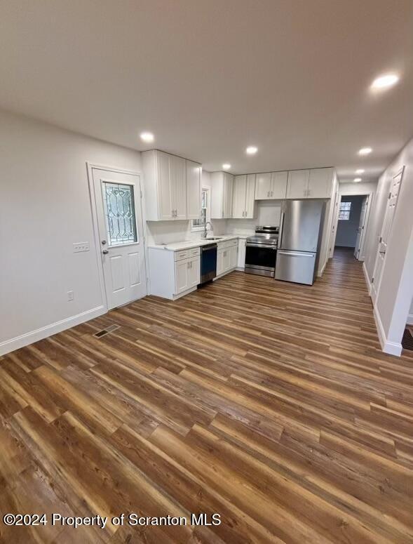 kitchen with white cabinets, sink, dark hardwood / wood-style flooring, and stainless steel appliances