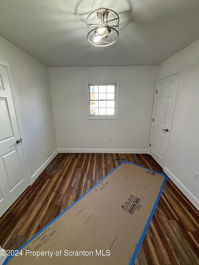 empty room with dark wood-type flooring