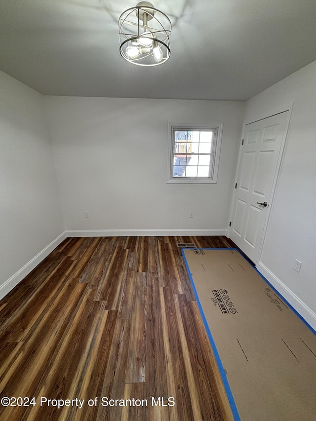 unfurnished room featuring dark wood-type flooring