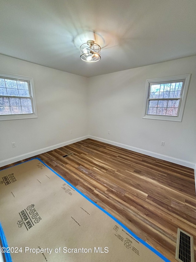 empty room with wood-type flooring