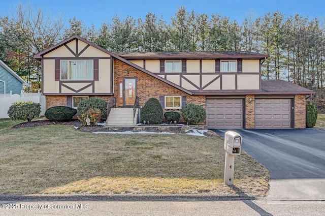 tudor-style house featuring a garage and a front yard