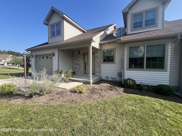 view of front of property featuring a front lawn, covered porch, and a garage