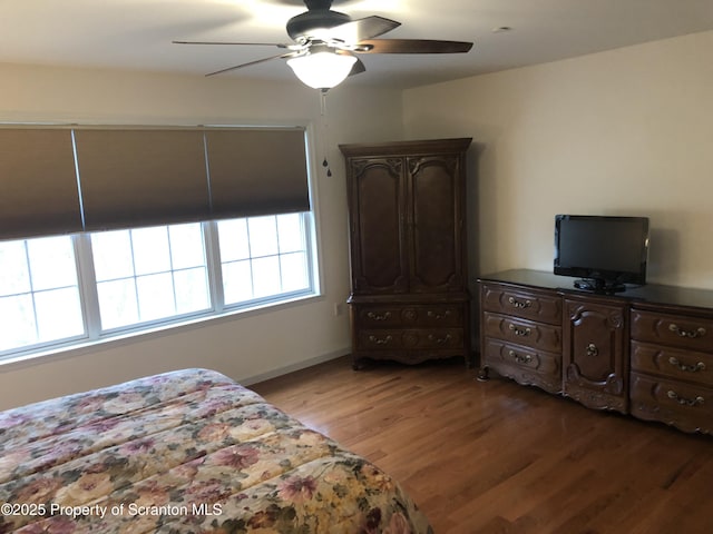 bedroom with ceiling fan and hardwood / wood-style flooring