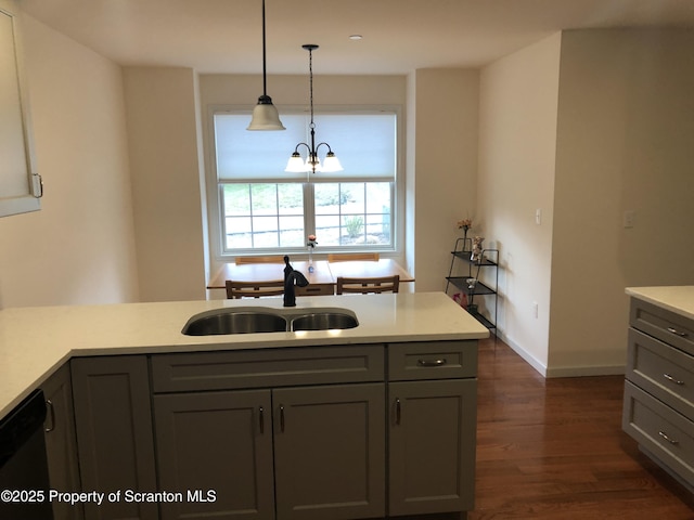 kitchen with gray cabinetry, sink, decorative light fixtures, a notable chandelier, and dishwasher