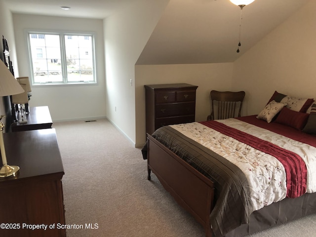 carpeted bedroom featuring vaulted ceiling