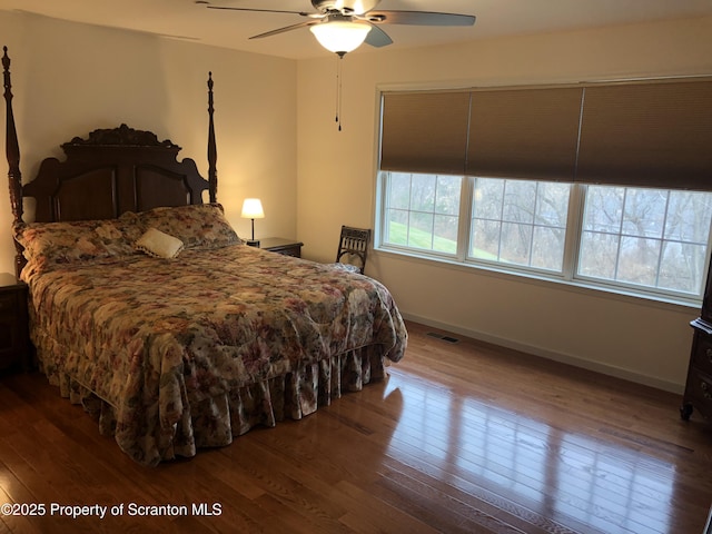 bedroom with ceiling fan and hardwood / wood-style flooring