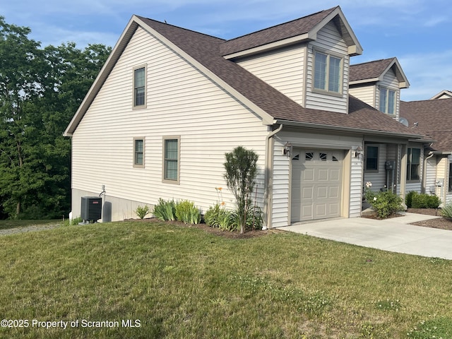 view of property exterior with roof with shingles, a yard, an attached garage, central AC, and driveway