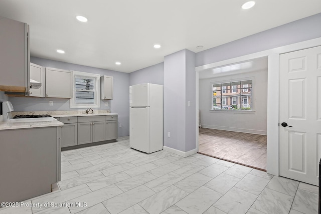 810 Pittston Ave, Scranton, PA 18505 - kitchen with freestanding refrigerator, gray cabinets, light countertops, stove, and recessed lighting