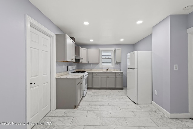 810 Pittston Ave, Scranton, PA 18505 - kitchen with white appliances, gray cabinets, light marble finish flooring, recessed lighting, and light stone countertops