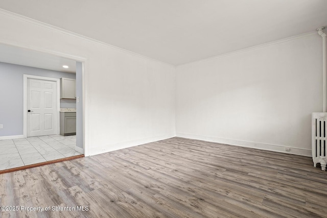 810 Pittston Ave, Scranton, PA 18505 - spare room featuring radiator, wood finished floors, and ornamental molding