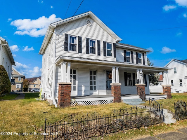 view of front of house with covered porch and a front lawn