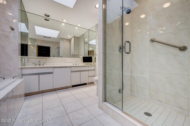 bathroom featuring double vanity, a skylight, a stall shower, and tile patterned floors