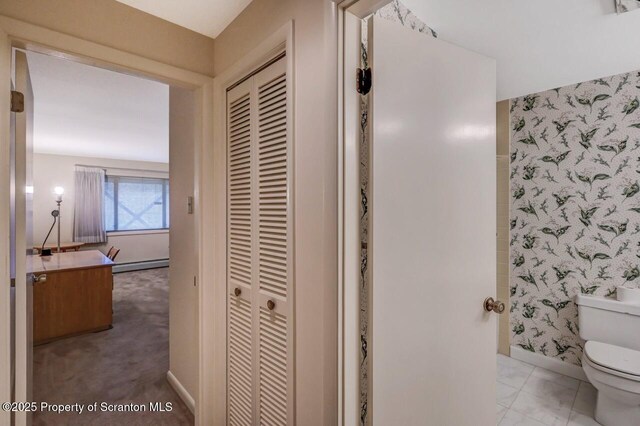 bathroom with wallpapered walls, a closet, a baseboard radiator, and toilet