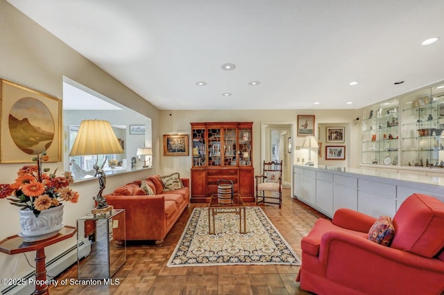 living area featuring a baseboard heating unit and recessed lighting