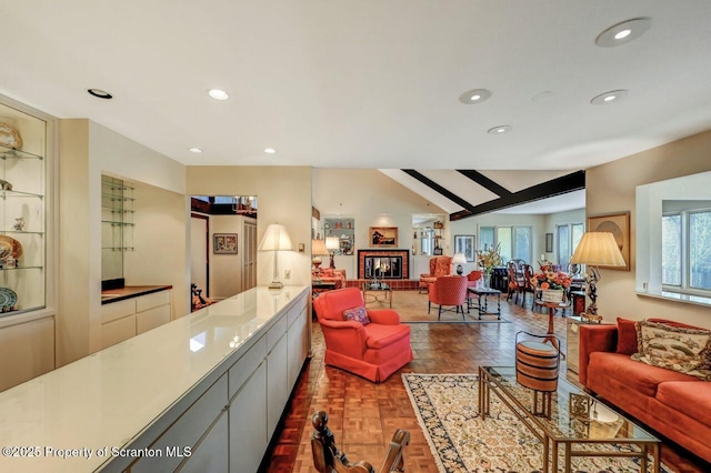 living area with vaulted ceiling and recessed lighting