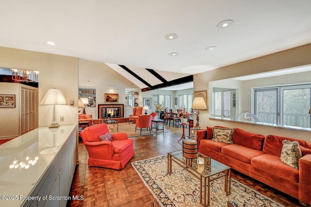 living room featuring a fireplace, lofted ceiling, and recessed lighting
