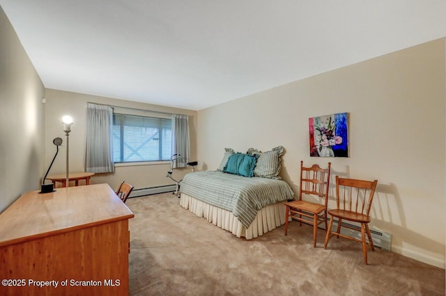 bedroom with baseboard heating, baseboards, and carpet flooring