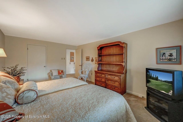 bedroom featuring carpet and baseboards