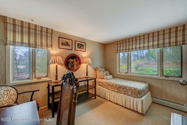 bedroom featuring a baseboard heating unit and carpet flooring
