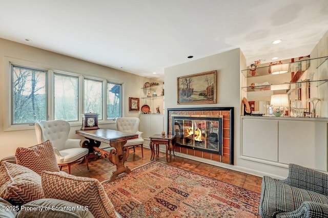living area with a fireplace, wood finished floors, and recessed lighting