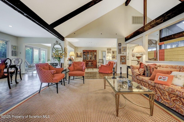 living area with beamed ceiling, visible vents, and high vaulted ceiling