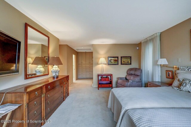 bedroom featuring light carpet