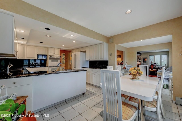 kitchen with decorative backsplash, light tile patterned flooring, high end fridge, and recessed lighting