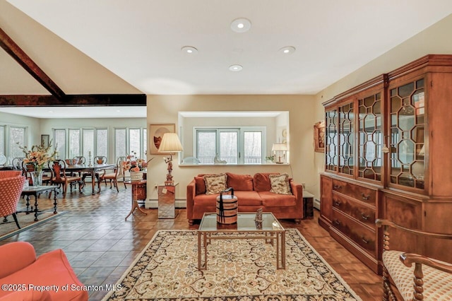 living room with a baseboard heating unit, baseboards, and recessed lighting