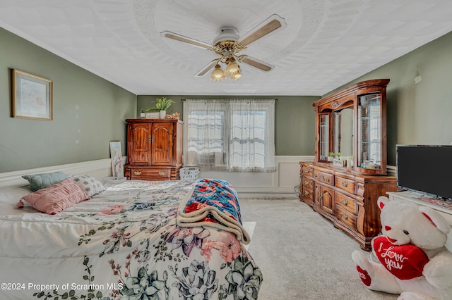 carpeted bedroom with a textured ceiling and ceiling fan