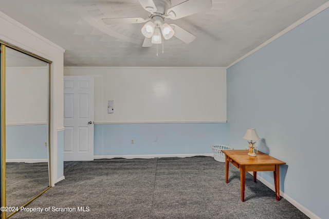 carpeted spare room with ceiling fan and crown molding