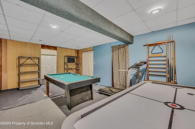 game room featuring carpet, a drop ceiling, wood walls, and billiards