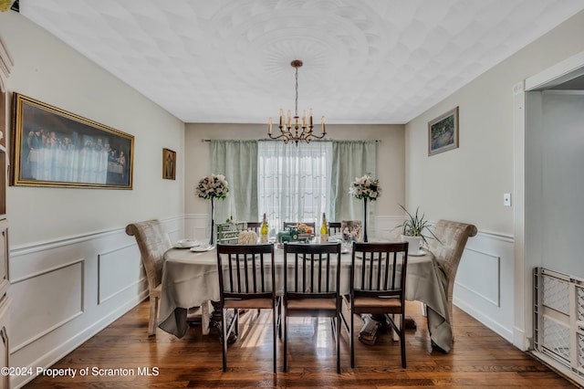 dining area with a chandelier and dark hardwood / wood-style floors