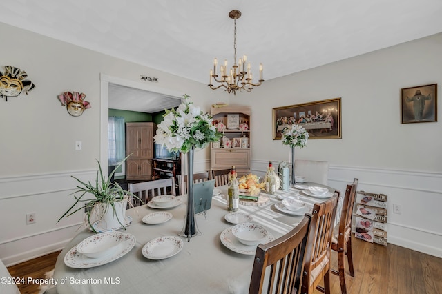 dining room featuring a chandelier and dark hardwood / wood-style floors