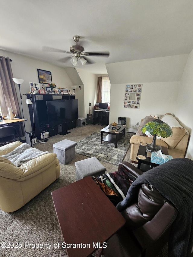 living area with carpet flooring, ceiling fan, and vaulted ceiling