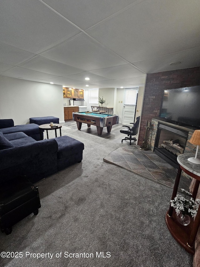 living room with a fireplace, pool table, and carpet