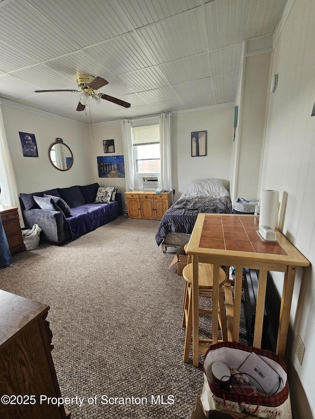 carpeted bedroom featuring crown molding and a ceiling fan